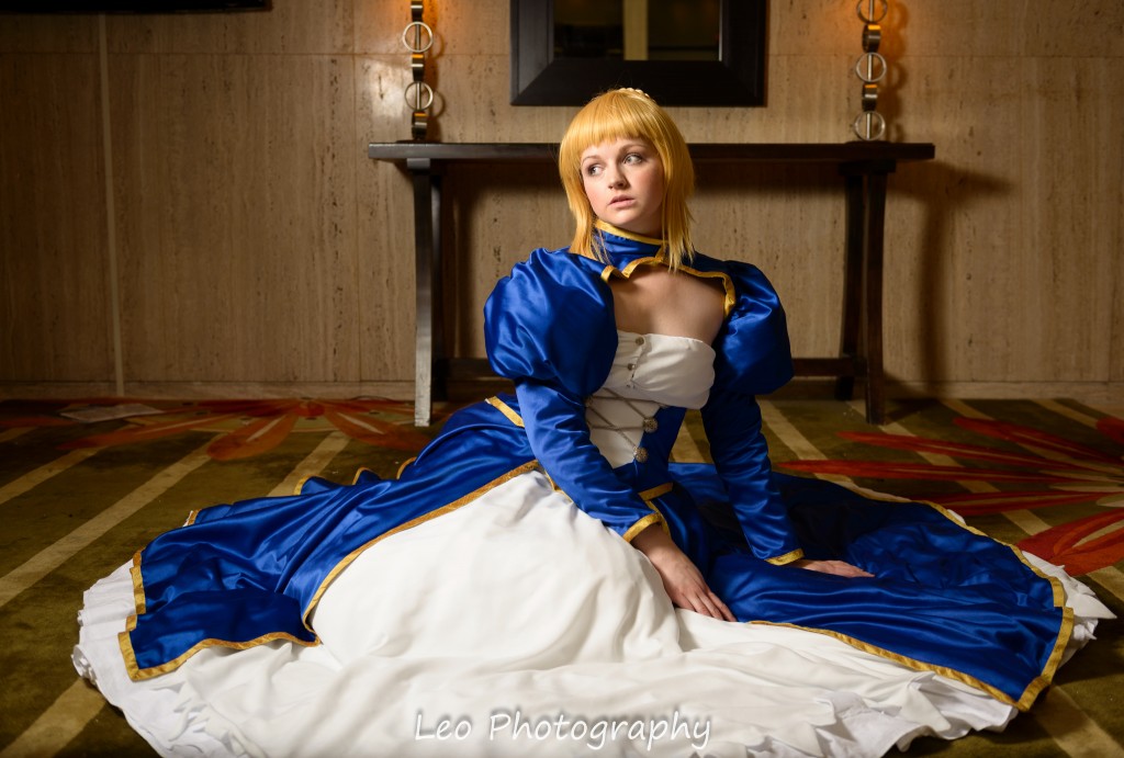 Photo of Saber cosplayer, seated in gown.