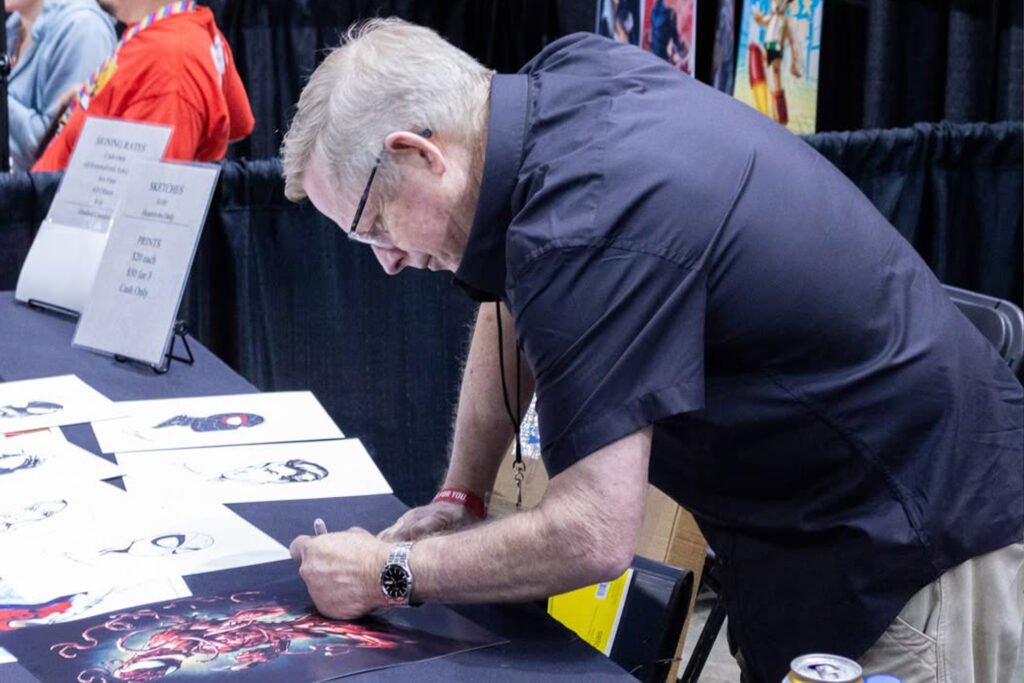 Bagley signing a comic book.